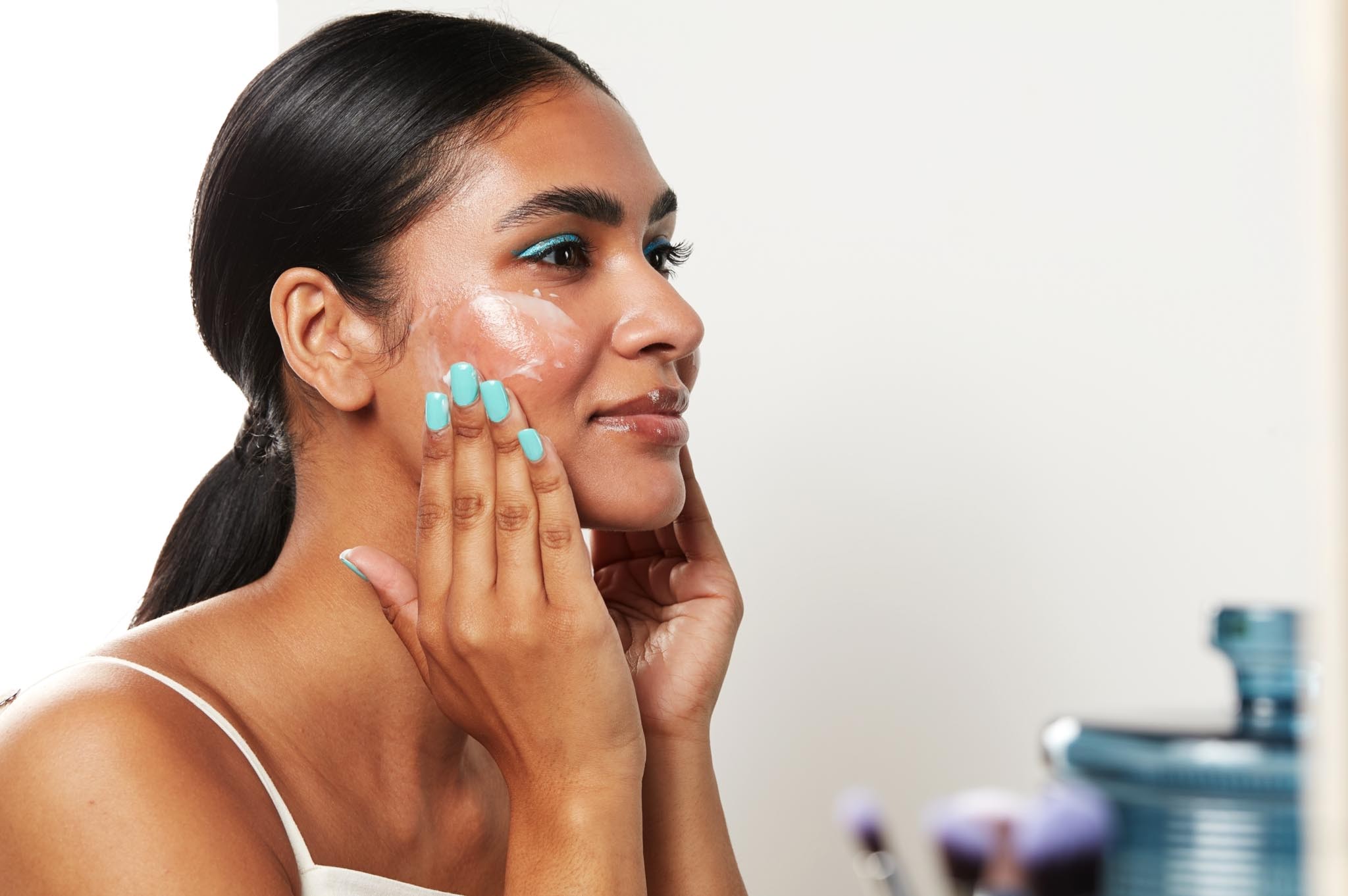 Woman applying skincare product