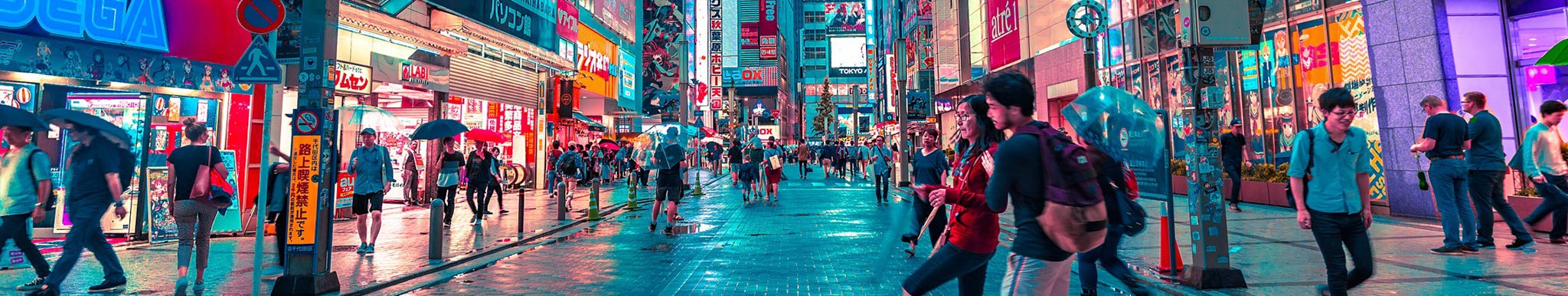 Brightly lit commercial street in Japan with shoppers